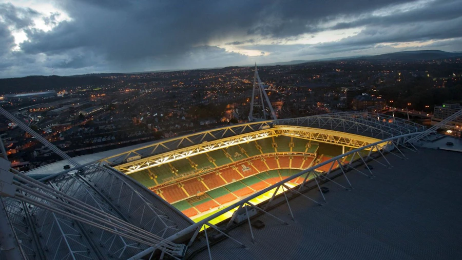 Aerial view of the Principality Stadium in Wales, surrounded by the city skyline and urban landscape.